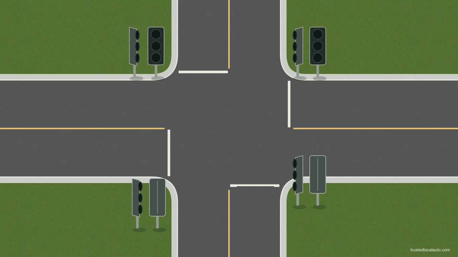 A junction with dark traffic-signal heads, white stop lines and empty approaches.