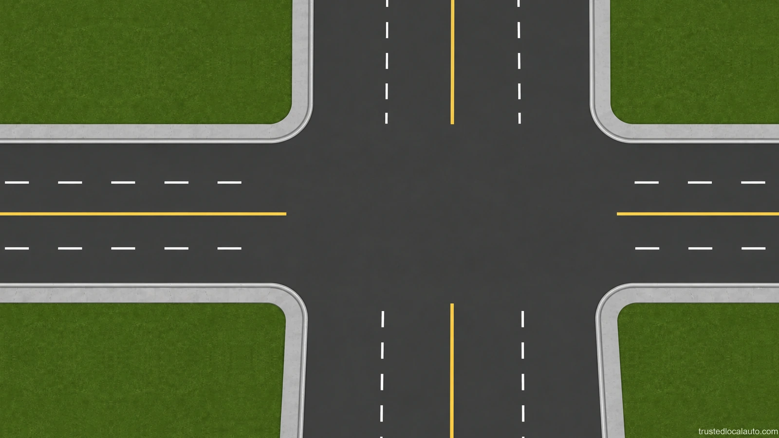 An empty intersection has two approach lanes in each direction, separated by white lane lines and a yellow centre line.