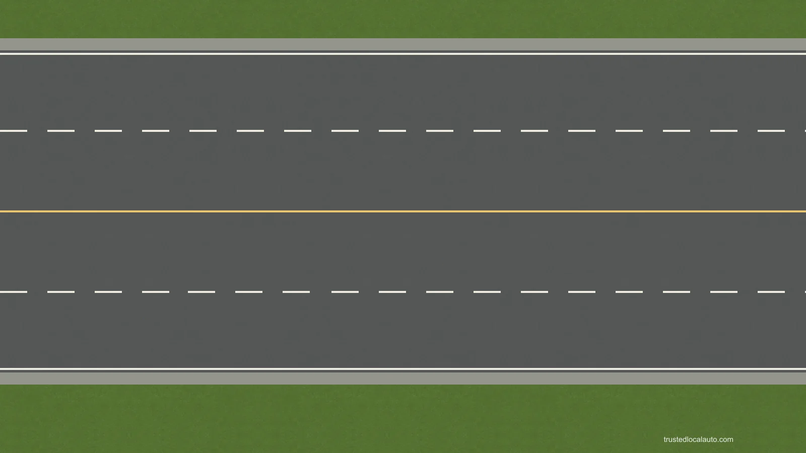 A four-lane road without traffic. Broken white lines divide lanes on each side of a yellow centre line. No travel arrows are shown.