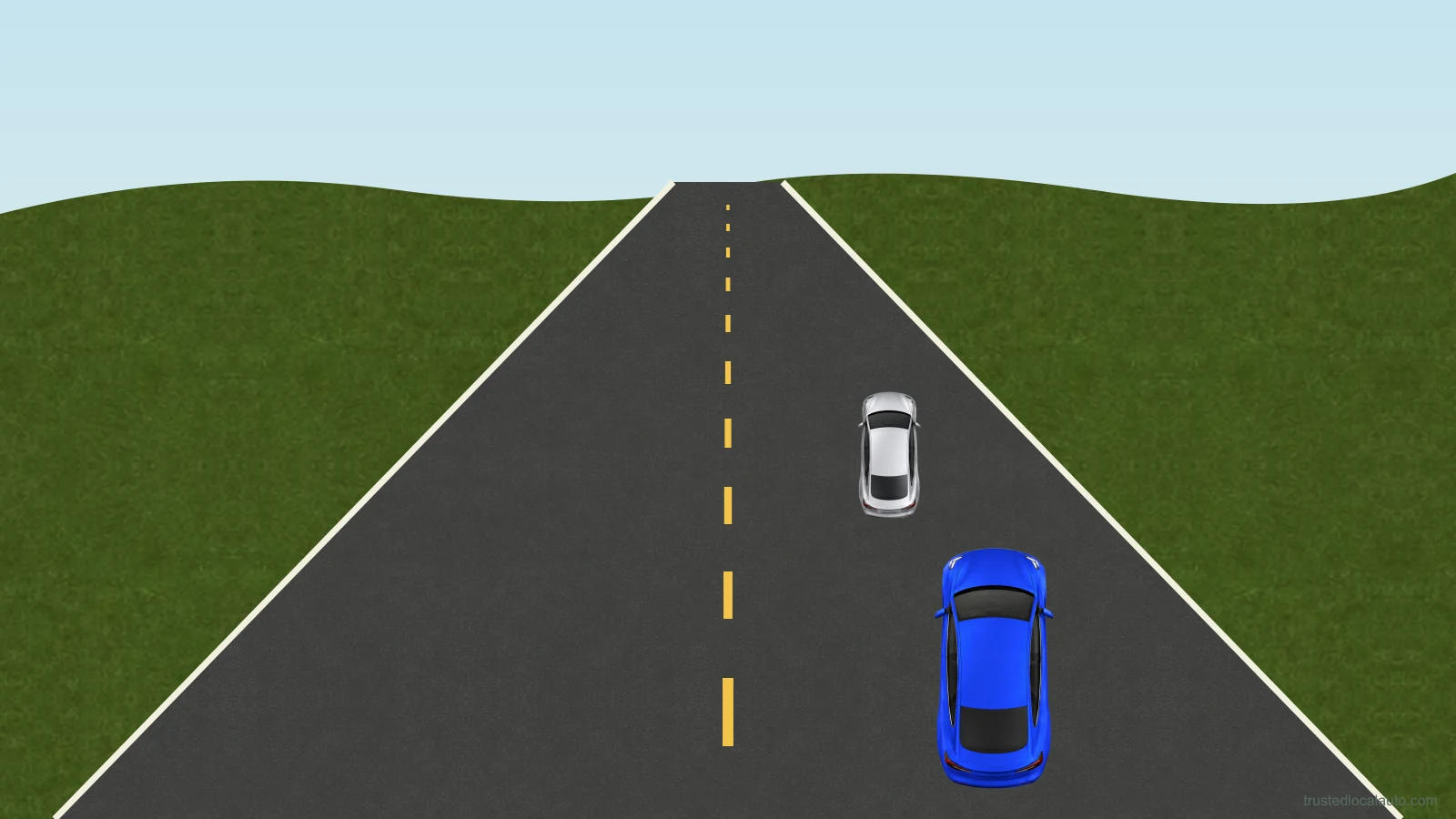 A car travels on a highway with the road visible well beyond the nearest traffic toward the distance.