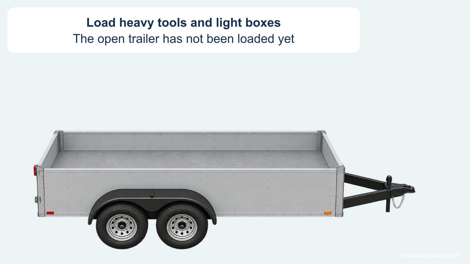 An empty open utility trailer is shown before heavy tools and light boxes are loaded.