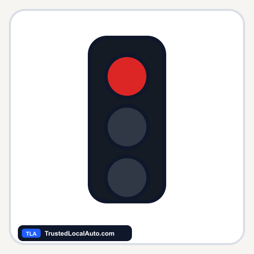 A three-lamp traffic signal with its top red circular lamp steadily lit.