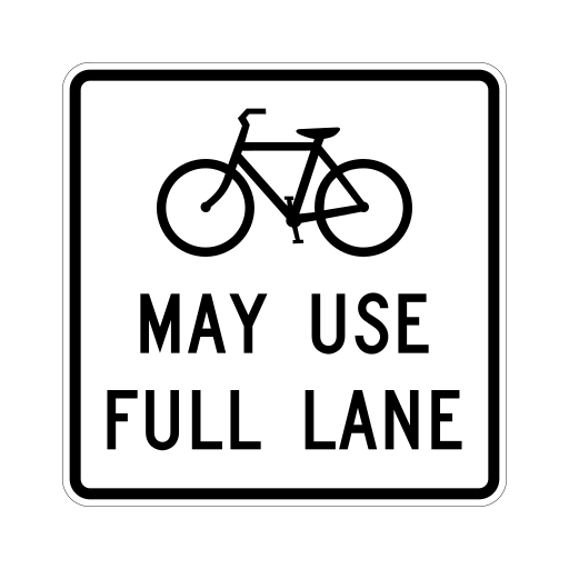 A white rectangular sign shows a black bicycle above the words MAY USE FULL LANE.