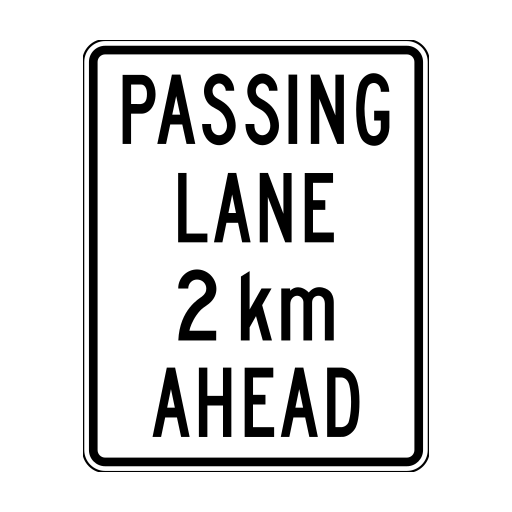 White rectangular sign reading PASSING LANE 2 km AHEAD.
