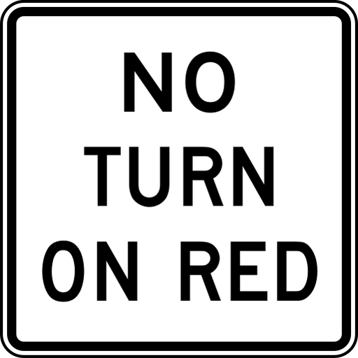 A white sign with a black border reads NO TURN ON RED in three lines of black letters.