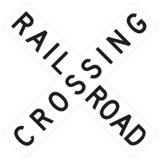 Two white boards cross diagonally and read RAILROAD CROSSING. No warning lights or gates are shown.