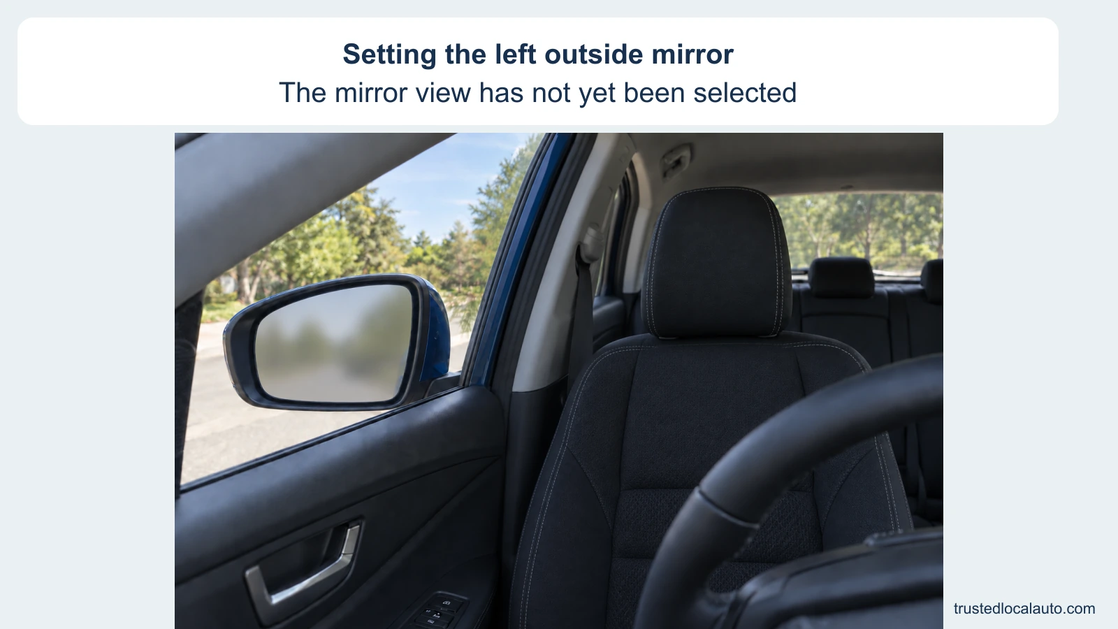 The empty driver’s place shows the closed left window and outside mirror. The mirror glass is an unresolved neutral reflection, with no own-car edge, selected angle or driver head position.