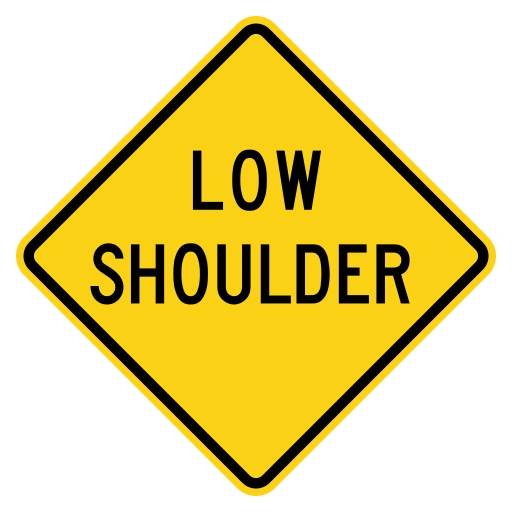 Yellow diamond sign with the black words LOW SHOULDER.