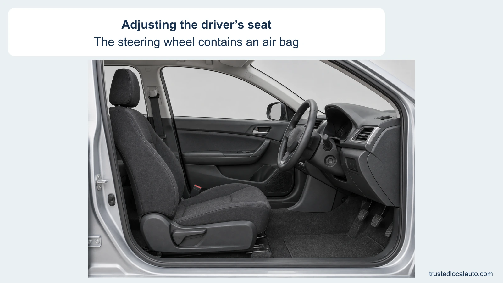 An empty driver seat and steering wheel are shown from the open side of a car.