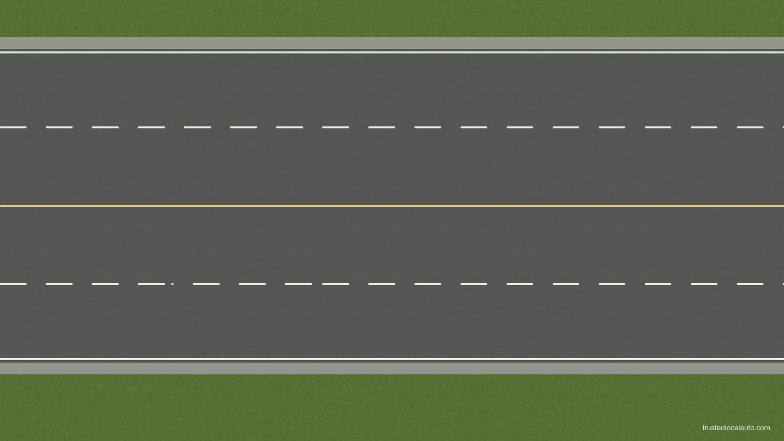 An empty four-lane road has a yellow centre divider and white dashed lane dividers. No cars or direction arrows explain the markings.