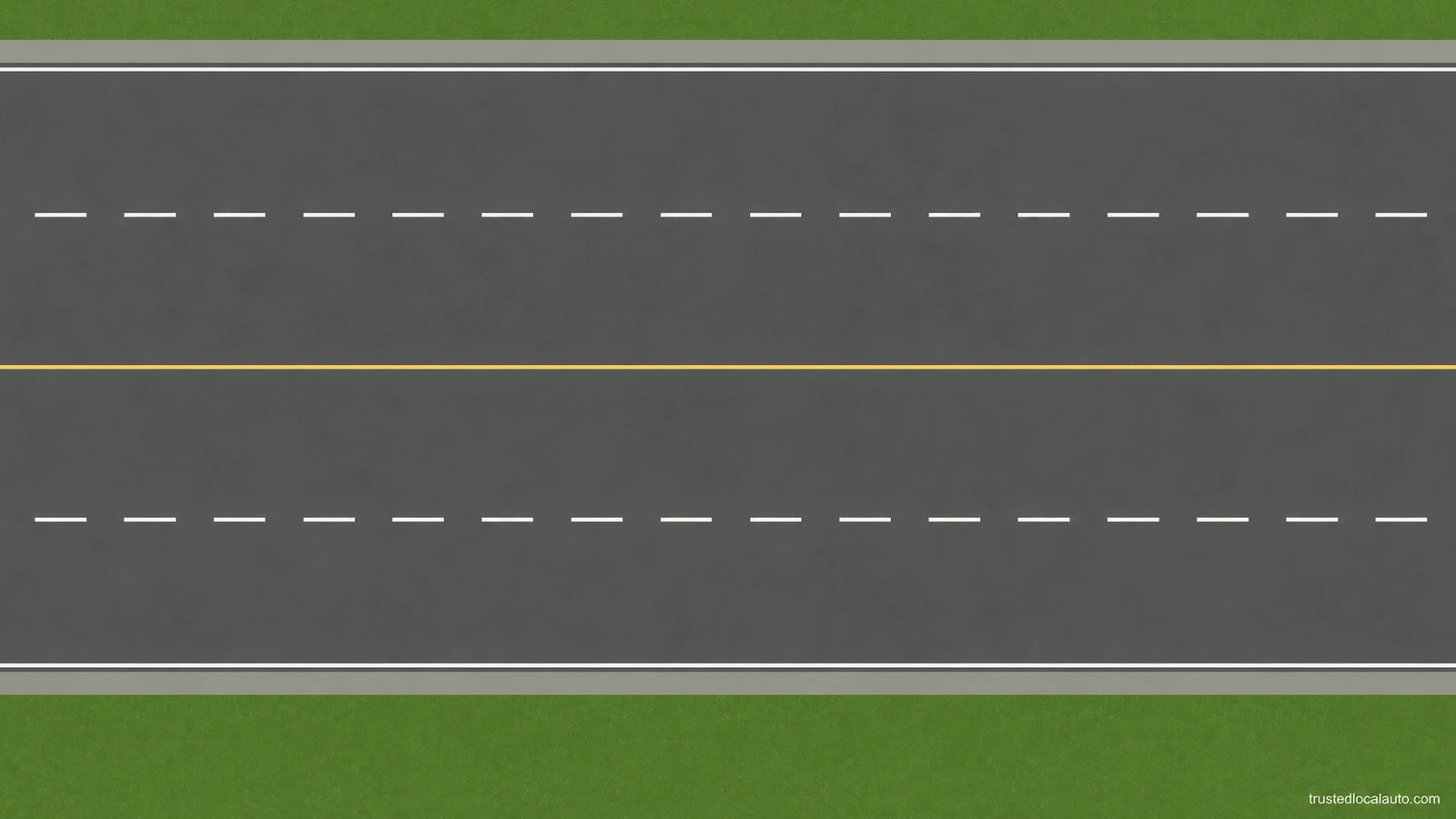 An empty road has broken white lane lines, yellow center markings and white outer edge lines; no cars or arrows show traffic direction.